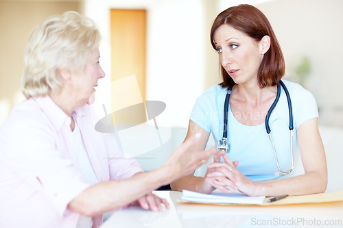 Image of Professional advice from a trusted a physician - Senior Health. An elderly woman expresses her concerns to a trusted doctor.