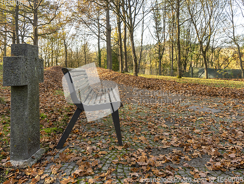 Image of bench in a cemetery at autumn time