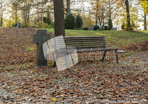 Image of bench in a cemetery at autumn time