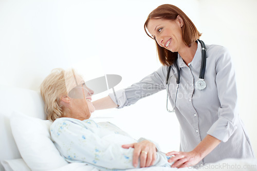 Image of Her patients are important to her - Senior Care. Mature doctor pays her elderly female patient a visit following an operation.