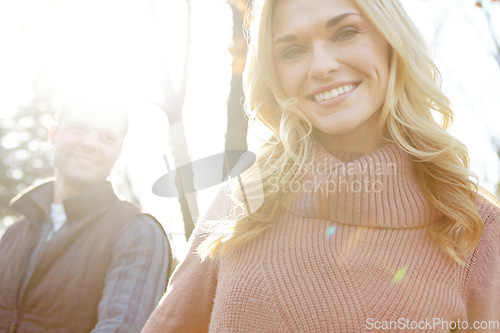 Image of Leading the way through the woods. A happy and loving couple spending time out in the woods together.