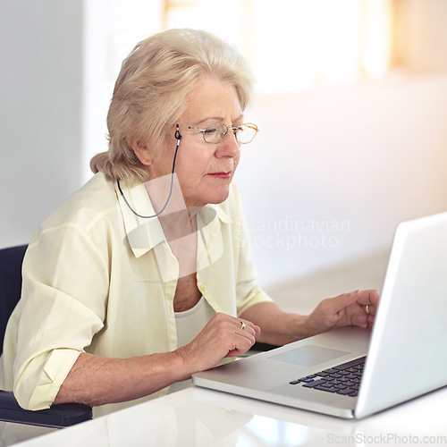 Image of Staying in touch with all her friends. a senior woman using her laptop at home.