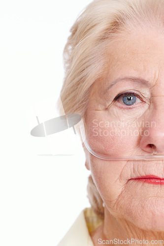 Image of Illness takes the better part of you ... are you covered for it. Sickly senior woman wearing a nasal cannula for oxygen isolated on white - Copyspace Cropped.