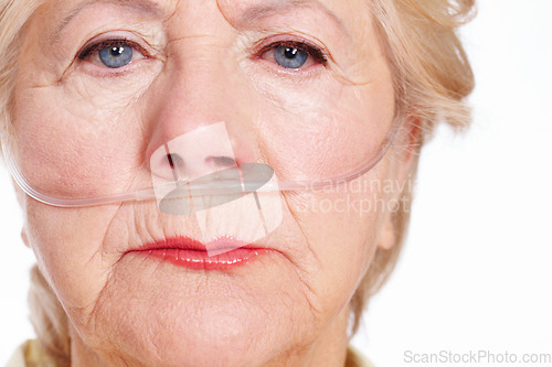 Image of Illness takes its toll ... are you covered for the eventuality. A sickly senior woman wearing a nasal cannula for oxygen isolated on white - Macro Closeup.