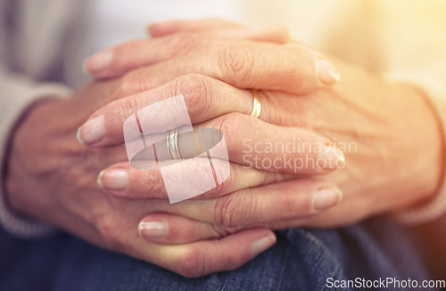 Image of Hands, retirement and nostalgia with a senior woman closeup indoor thinking about a past memory. Fingers, wrinkles and old age with a mature female pensioner sitting in her home feeling lonely