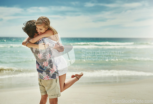 Image of Hold me tight and never let me go. an affectionate young couple embracing on the beach.