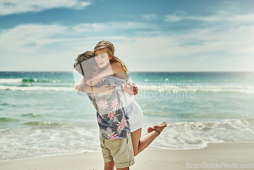 Image of You make me so happy. an affectionate young couple embracing on the beach.