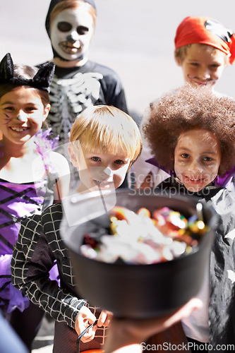 Image of Every childs favorite holiday. Portrait of a group of little children trick-or-treating on halloween.