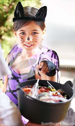 Image of She loves dressing up. Little children trick-or-treating on halloween.