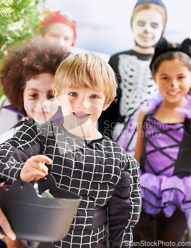 Image of Trick-or-treating cuties. Portrait of happy little children trick-or-treating on halloween.