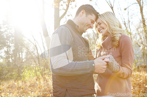 Image of Sharing a special moment. An affectionate and romantic young couple spending time together in the woods.