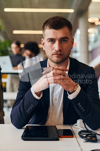 Image of In a modern office setting, a determined director sits confidently at his desk with crossed arms, exemplifying professionalism, leadership, and unwavering resolve in the contemporary corporate world