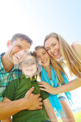 Image of Enjoying a day of family fun outdoors. A cute young family spending time together outdoors on a summers day.