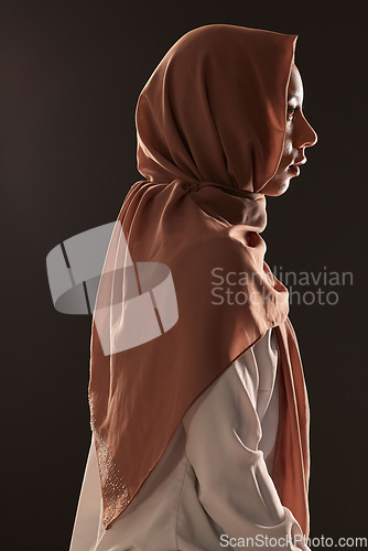 Image of Muslim woman, profile and hijab for religion, islam or praise in faith against a dark studio background. Side view of Islamic female person or model with scarf in fashion for culture or tradition