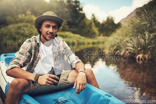 Image of I come to the lake whenever I need an escape. Portrait of a young man going for a canoe ride on the lake.