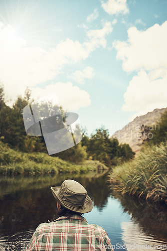 Image of Get out there and explore the great outdoors. Rearview shot of a young man going for a canoe ride on the lake.