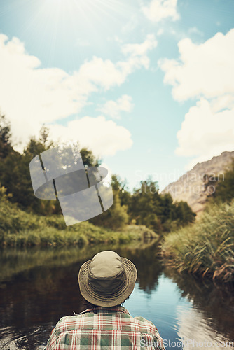 Image of Spending the day in serenity. Rearview shot of a young man going for a canoe ride on the lake.