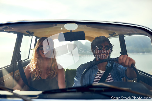 Image of Hitting the open road. an affectionate young couple taking a roadtrip together.