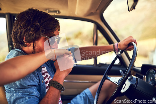 Image of For the love of travel. an affectionate young couple taking a roadtrip together.