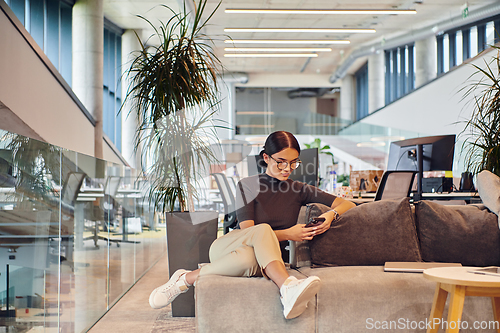 Image of In a modern startup office, a businesswoman collaboratively tackles various business problems and challenges, surrounded by their engaged colleagues, fostering innovation and productivity