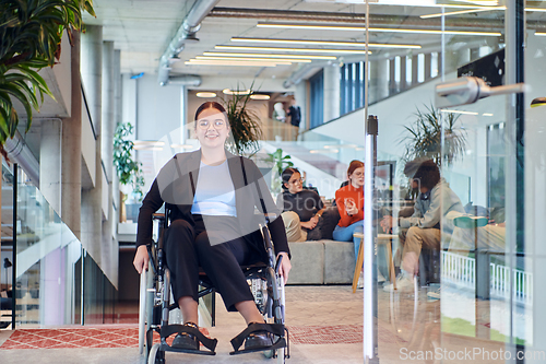 Image of In a modern office, a young businesswoman in a wheelchair is surrounded by her supportive colleagues, embodying the spirit of inclusivity and diversity in the workplace