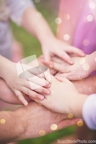 Image of Family fun. Closeup shot of a family with their hands in a huddle outside.