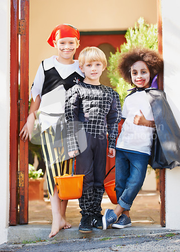 Image of What wonderful costumes. Little children trick-or-treating on halloween.