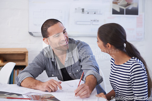 Image of Hes very happy with her progress. a man and young woman discussing blueprints.