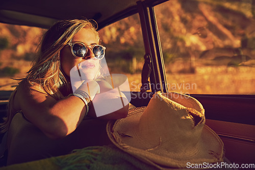 Image of Life is a highway. Portrait of a happy young woman sitting inside a car during a roadtrip.