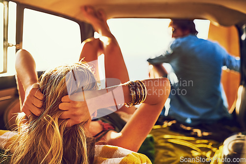 Image of Adventurers at heart. Rearview shot of a young couple relaxing inside their car during a roadtrip.