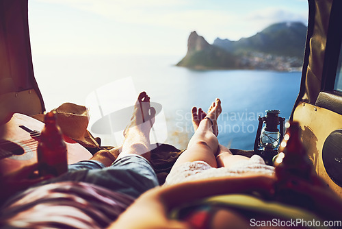 Image of Some places you have to see for yourself. an unidentifiable young couple relaxing inside their car during a roadtrip.