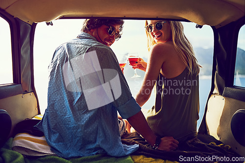 Image of We love getting lost. Rearview shot of a young couple relaxing inside their car during a roadtrip.