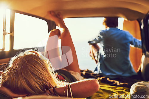 Image of Theyll never stop exploring. Rearview shot of a young couple relaxing inside their car during a roadtrip.