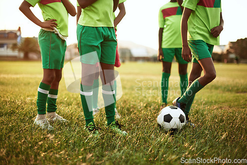 Image of Starting off with a friendly match. Closeup shot of a group of young boys playing soccer on a sports field.