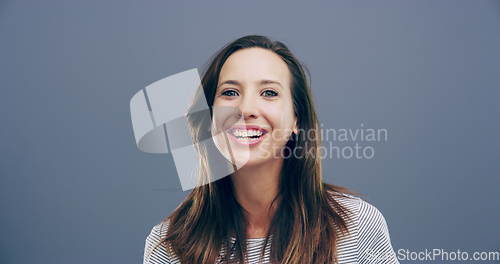Image of Face, happy or woman laughing at joke or crazy comedy in studio isolated on gray background. Funny, excited model or silly female person with freedom, goofy smile or joy to relax alone with humor