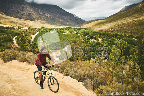 Image of Cycling along the most scenic route. a young man cycling along a trail.