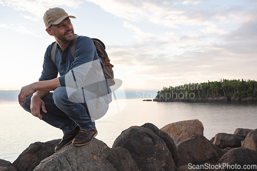 Image of Life is a lot more fun when youre exploring. a man wearing his backpack while out for a hike on a coastal trail.