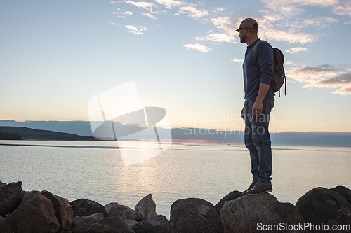 Image of I came across so much beauty on this trail. a man looking at the ocean while out hiking.