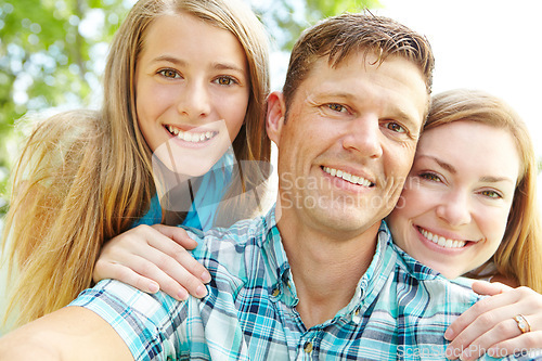 Image of Proud of my two girls. A happy young family relaxing together on a sunny day.