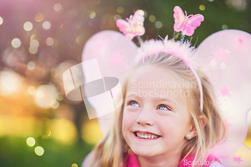 Image of Look My fairy dust is falling. an adorable little girl dressed up as a fairy and having fun outside.