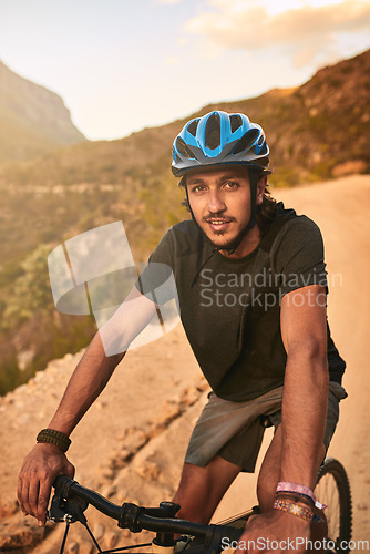 Image of The best invention after the wheel Putting two together. Portrait of a young man cycling along a trail.