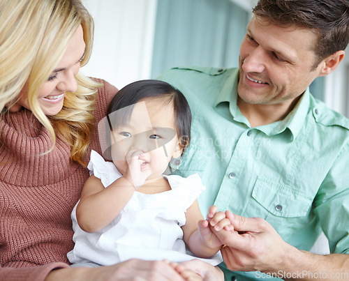 Image of Shes so adorable. A happy couple spending time with their beautiful adopted daughter while at home.