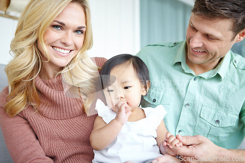 Image of Parenthood brings us such joy. A happy couple spending time with their beautiful adopted daughter while at home.