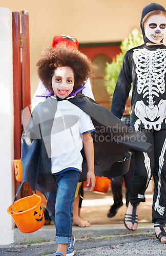 Image of What a great costume. happy little children trick-or-treating on halloween.