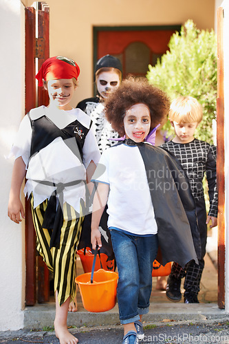 Image of What little monsters. Little children trick-or-treating on halloween.