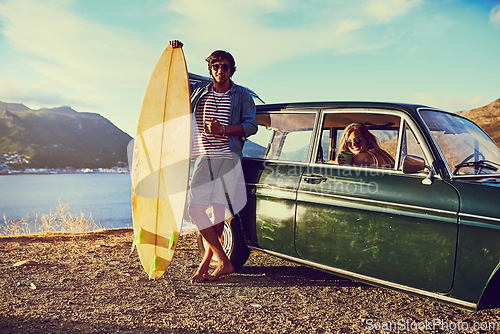 Image of Blessed are the curious, for they will have adventures. Portrait of a happy young couple posing with their car on a roadtrip.