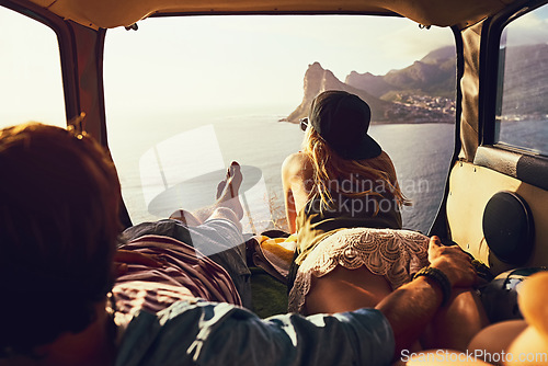 Image of They cant get tired of this view. Rearview shot of a young couple relaxing inside their car during a roadtrip.