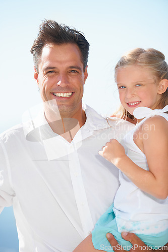 Image of Relaxing outdoors with his cute daughter. A happy father carrying his adorable daughter as they enjoy a day in the sun.