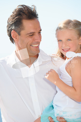 Image of Love and bonding. A happy father carrying his adorable daughter as they enjoy a day in the sun.