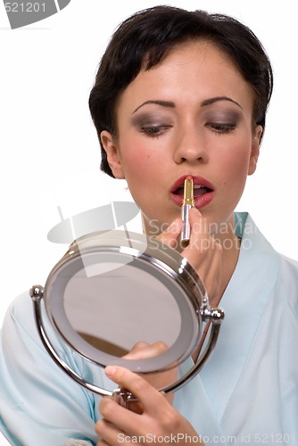 Image of Woman putting on makeup